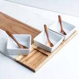 Charcuterie board with ceramic bowls and serving trays